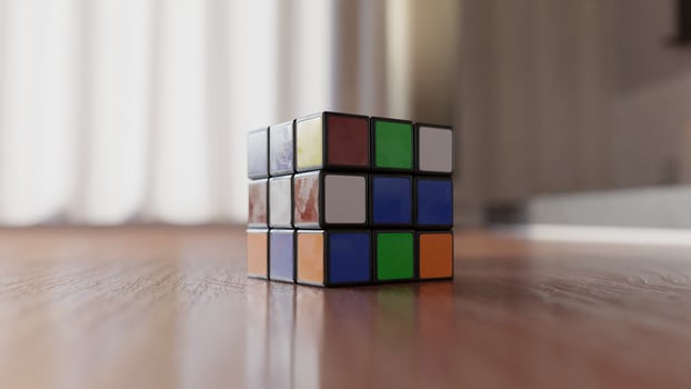 A rubik cube sitting on a wooden floor photo