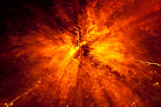 An explosion of light and fire in the dark photo