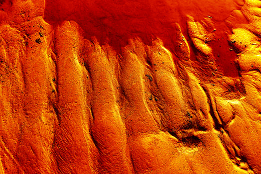 A close up of a surfboard with a red sky photo