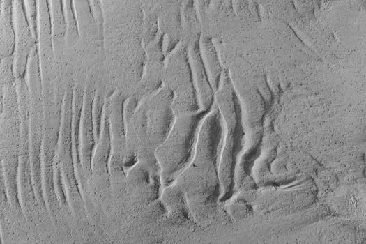 A black and white photo of a wall with some lines