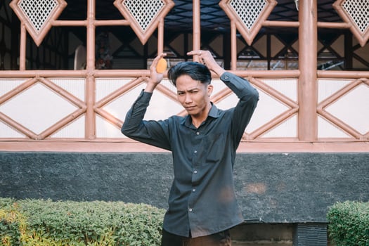 Southeast Asian man combing his hair photo
