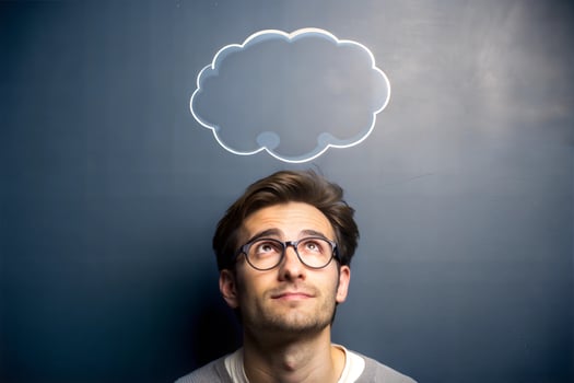 On the board next to the young man with glasses there is a cloud drawn for recording his thoughts. photo