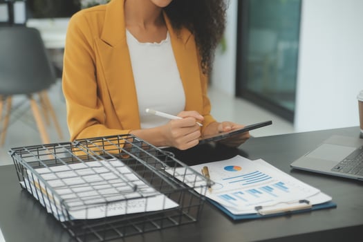 Close up Business woman using calculator and laptop for do math finance on wooden desk, tax, accounting, statistics and analytical research concept photo