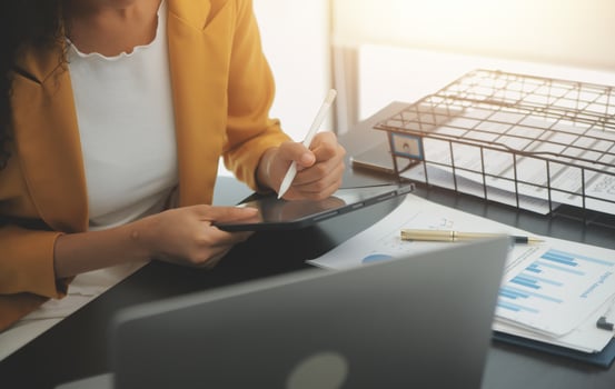 Close up Business woman using calculator and laptop for do math finance on wooden desk, tax, accounting, statistics and analytical research concept photo