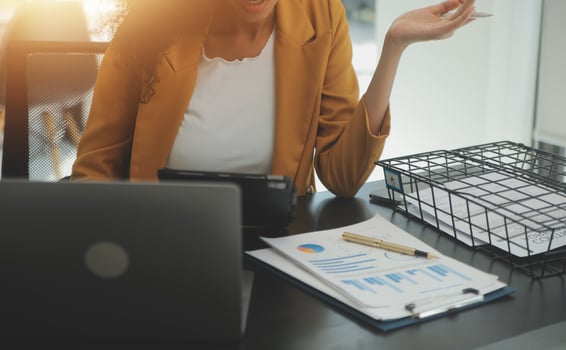Close up Business woman using calculator and laptop for do math finance on wooden desk, tax, accounting, statistics and analytical research concept photo