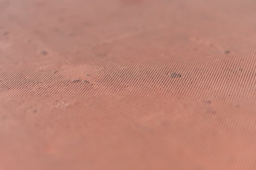 A close up of a red surface with a small hole photo
