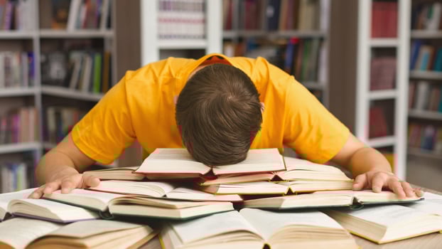 Student studying hard exam and sleeping on books in library, free space photo