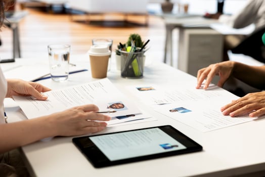 Talent acquisition experts looking at CVs on tablet to vet selected applicants. Recruiters reading resumes on device sitting on office desk, assessing candidate work experience photo