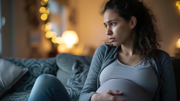 A pregnant woman gets emotional while talking about the fears and concerns she has for her and her babys health during the pandemic photo