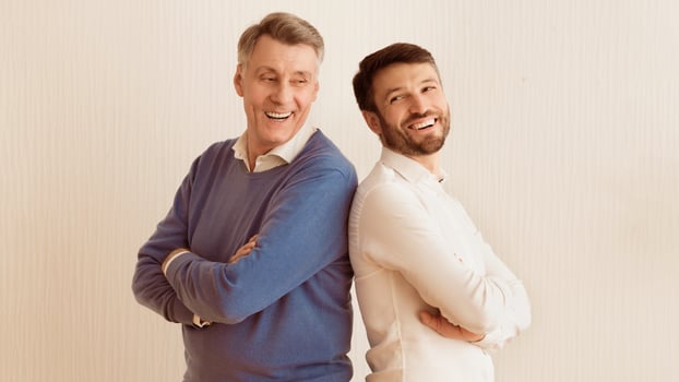 Mature Man And Senior Father Standing Back-To-Back Crossing Hands Laughing On White Background. Panorama photo
