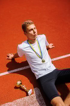 Young Athlete Celebrating Victory on Track photo