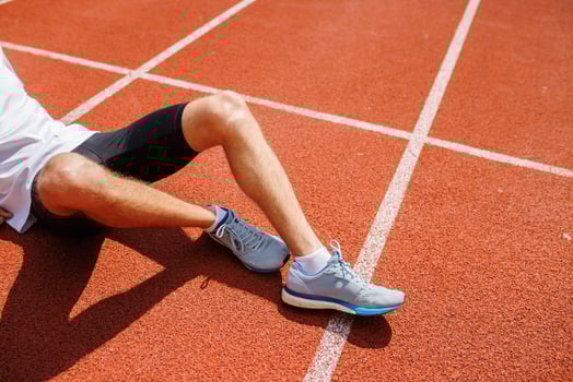 Runner resting on track after a run photo