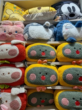 Soft toys on the shelves in a children's store for sale photo