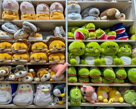 Soft toys on the shelves in a children's store for sale photo
