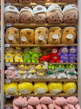Soft toys on the shelves in a children's store for sale photo