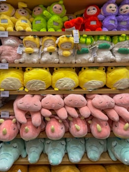 Soft toys on the shelves in a children's store for sale photo