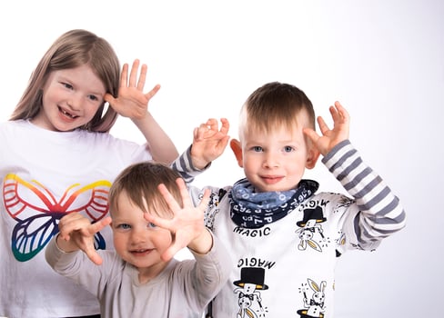 Three faces of happy little children-focus on sister between the two brothers photo