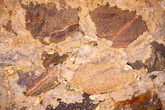 Stone background, rock wall backdrop with rough texture. Abstract, grungy and textured surface of stone material. Nature detail of rocks. photo