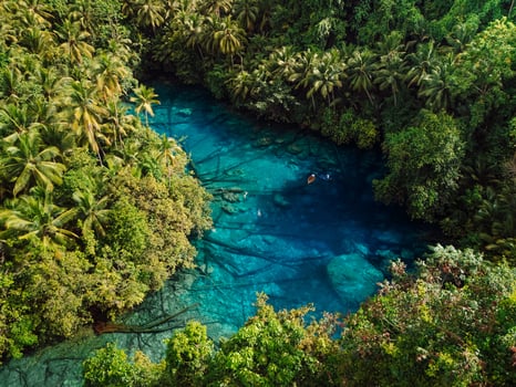 Transparent lake with crystal blue fresh water in Sulawesi, Indonesia. Aerial view photo