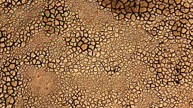 Aerial View of Cracked Earth Texture in Drought-Affected Area Highlighting Climate Change and Environmental Impact photo