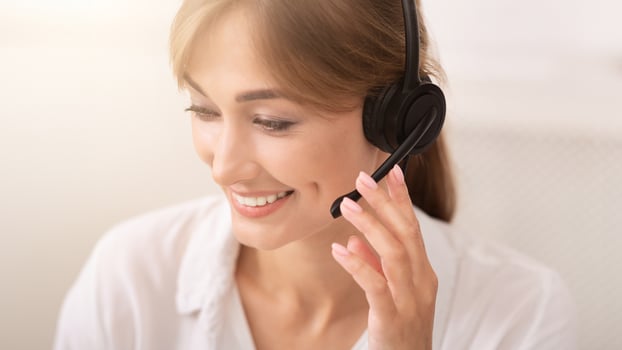 Customer Support Hotline. Positive Lady In Headset Talking With Client Working In Call Center Office. photo