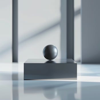 A black ball on top of a white box photo