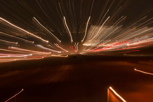 Abstract Light trails at night leaving bright squiggly lines of white and red trails photo