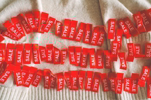 Cozy sweater adorned with holiday sale tags photo
