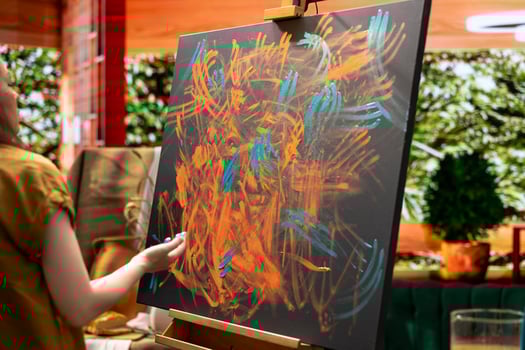 In a creative workshop, female artist mixes pigments with her fingers to achieve the perfect hue. The creation is an abstract masterpiece reflecting her finger painting skill and inspiration. photo