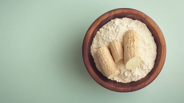 Cassava flour on brown wooden bowl and some fruits for baking, gluten free copy space photo