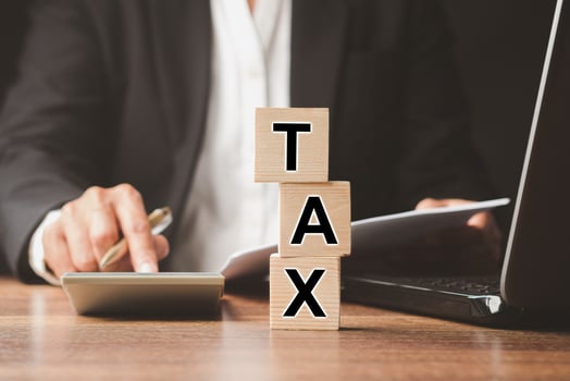 Businessman in a suit using a calculator and individual income tax payment form photo