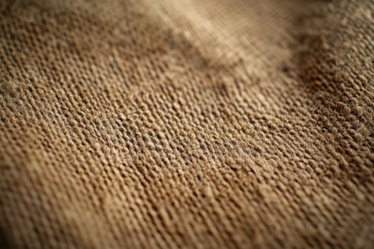 Close-up view of textured burlap fabric showcasing its natural fibers and weave detail photo
