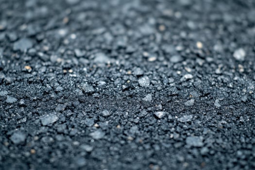Close-up view of freshly laid asphalt showing texture and detail on a road surface photo