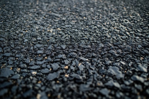 Close-up view of textured asphalt surface during daylight showcasing road construction details photo