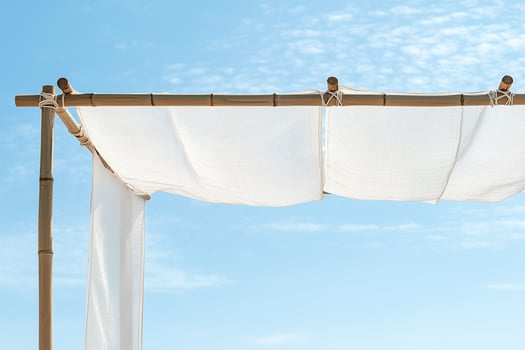 White canvas canopy hanging on bamboo frame under blue sky sukkah photo