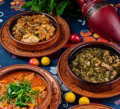 Three earthenware pots filled with delicious food from georgian cuisine standing on a table photo