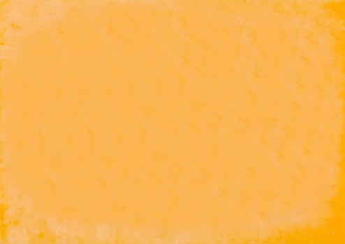 Vacuum packed block of cheddar cheese close up background photo