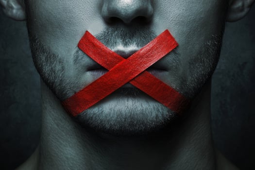 This powerful artwork illustrates the limits on free speech, depicting a mans mouth bound with bright red tape, symbolizing the constraints on genuine expression faced in society today photo