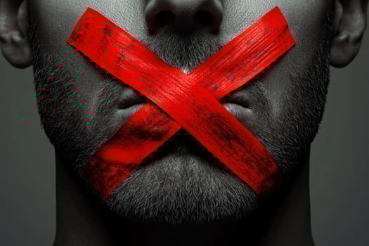 This vivid image of red tape across a mans mouth symbolizes the suppression of free speech, highlighting ongoing censorship struggles and the importance of communication in a democratic society photo
