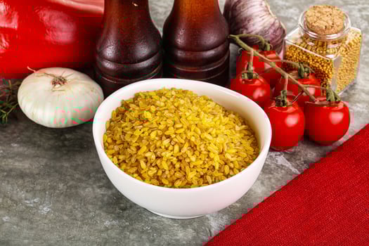 Dry wheat bulgur cereal heap photo