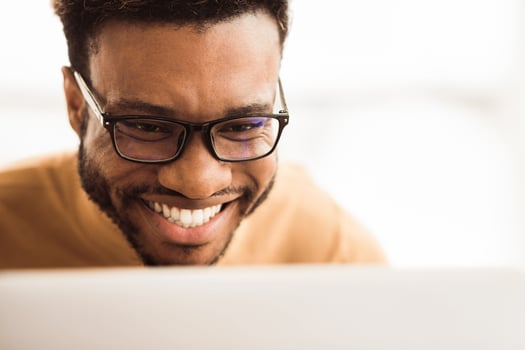 Software Testing. Close up of happy african programmer coding and developing new app or website. Copy space photo