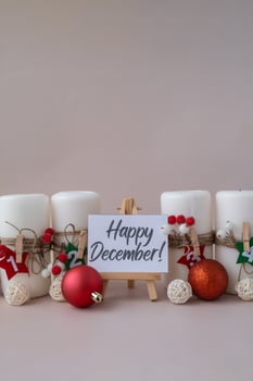 Greeting card with text HAPPY DECEMBER New year and Christmas preparation. Four-week advent candles on table. Handmade eco-friendly decor. Sustainable Christmas decoration. Postcard photo