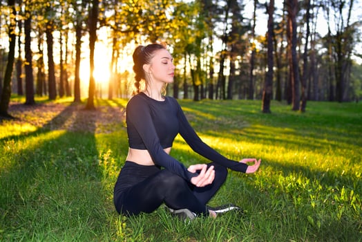 Sunset Meditation in Forest, Woman Practicing Yoga Outdoors, Serene and Peaceful photo