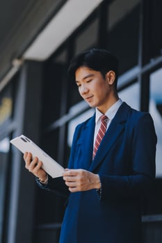 Businessman using tablet and enjoying in coffee break in front of the the corporation. Business, lifestyle concept photo
