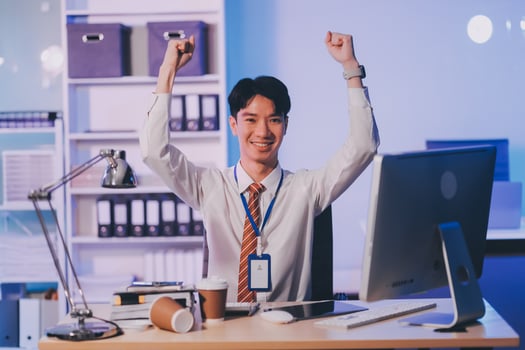 Asian business man standing in office using smartphone at night case accomplished photo