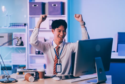 Asian business man standing in office using smartphone at night case accomplished photo