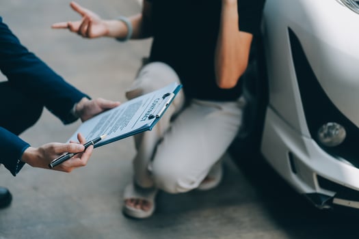 A young businesswoman is navigating car insurance options at her desk, considering premiums, deductibles, and coverage while understanding policies and managing claims efficiently. photo