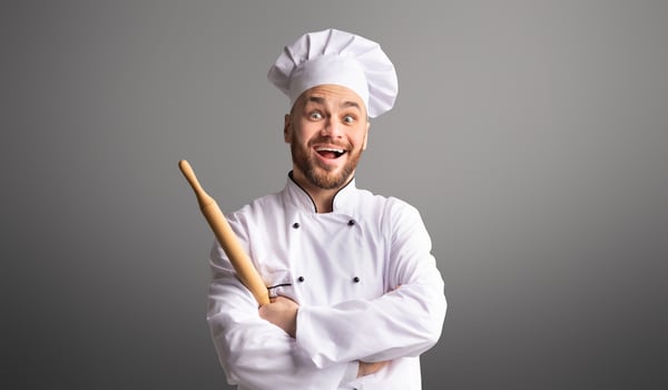 Professinal Baker. Excited Male Chef Holding Rolling Pin For Dough Posing Over Black Studio Background photo