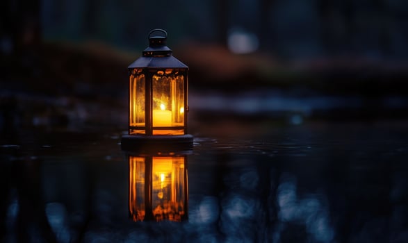 Single floating candle on rippling water, soft golden glow illuminating the scene photo