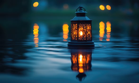 Lantern with a flickering light floating on still water photo